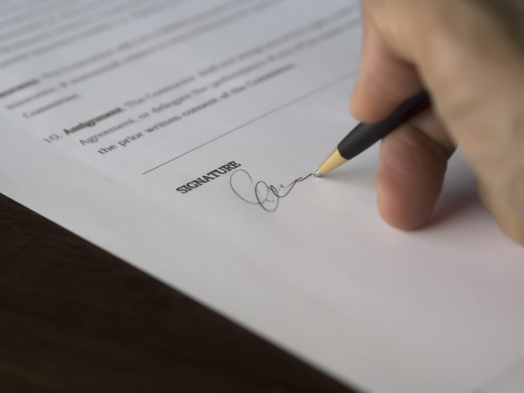 Signing a Contract for an Apartment Rental With a Pen