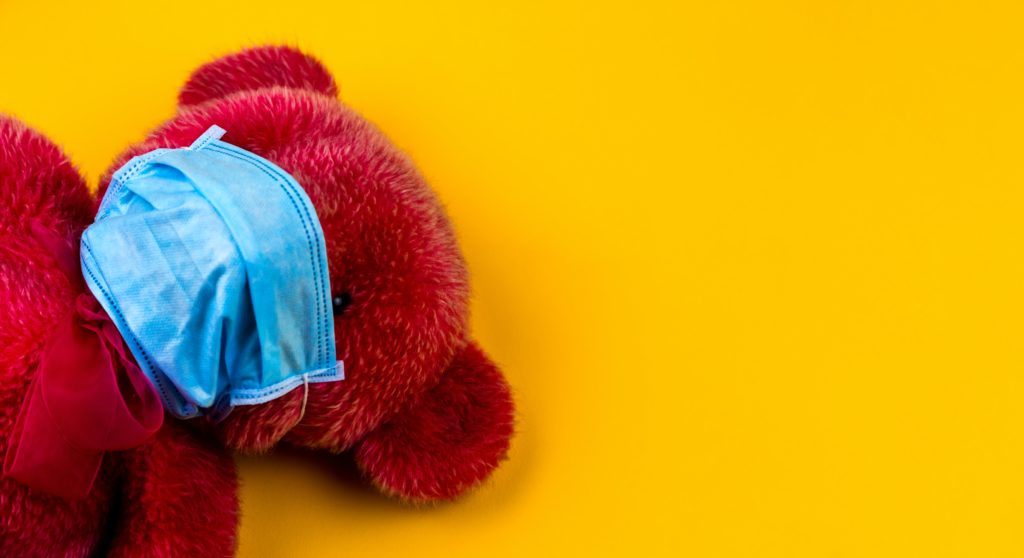 red teddy bear with mask on