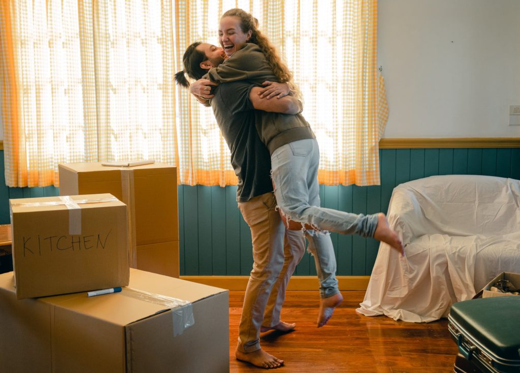 two people hugging in a new apartment