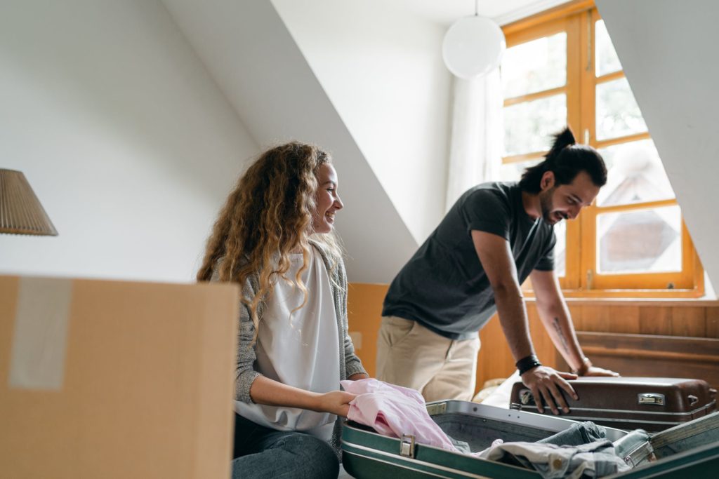 man and woman packing to move