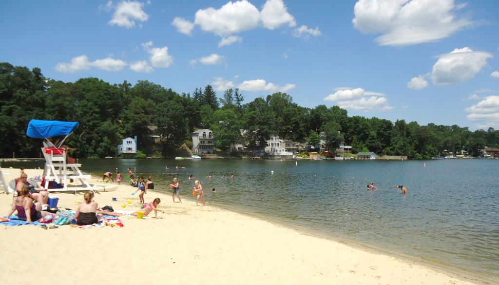 Lake Hopatcong State Park NJ beach scene houses in distance