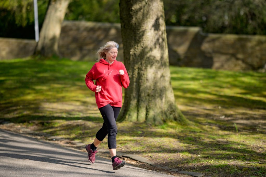 Older woman jogging outside
