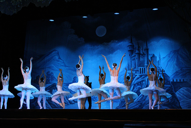Ballet performance with dark castle scenic mural setting on stage