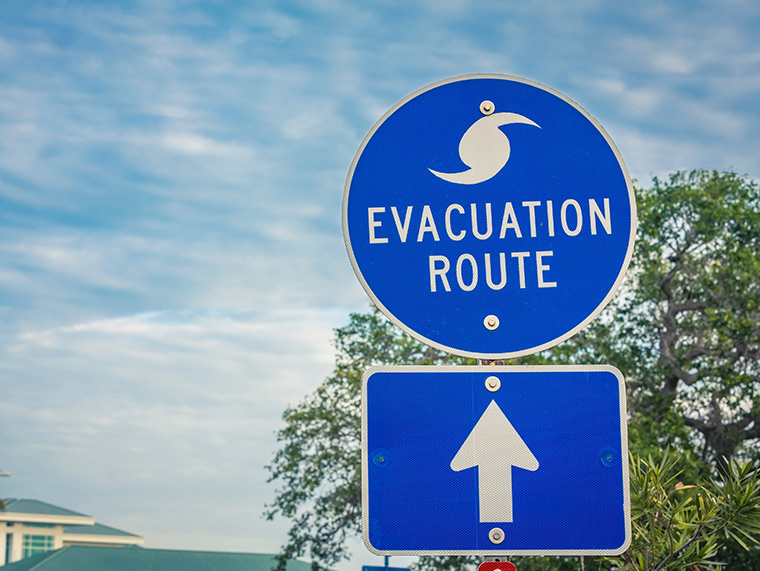 Close up view of blue hurricane evacuation sign.