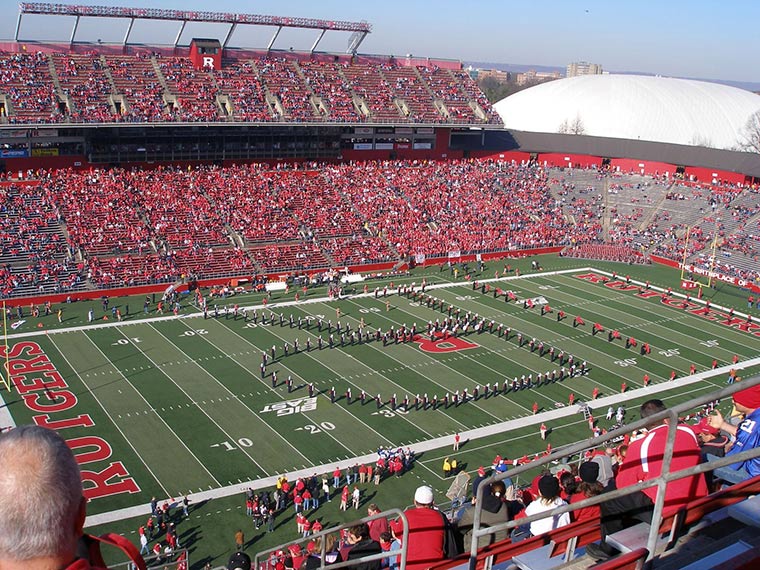 An elevated perspective of Rutgers University Football Stadium featuring the band creating an 'R' on the football field.