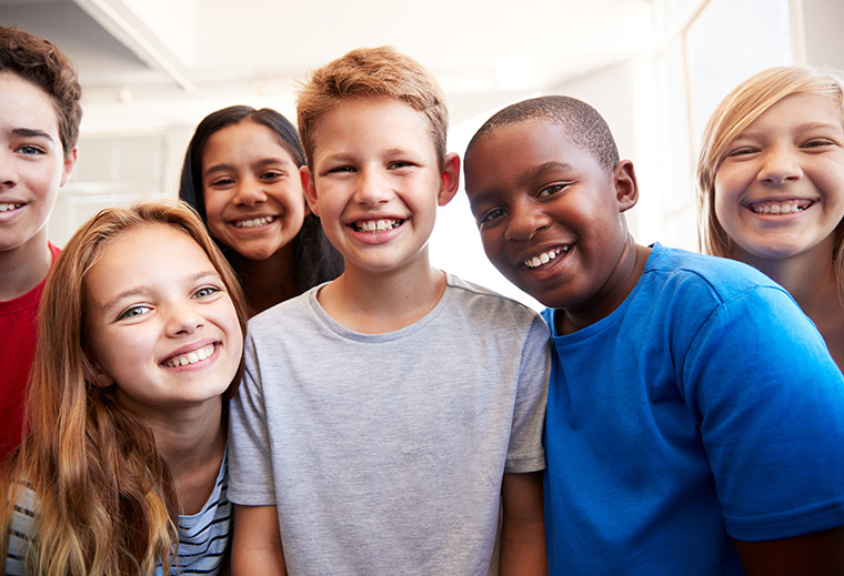 Chearfull elementary school children smiling into camera.