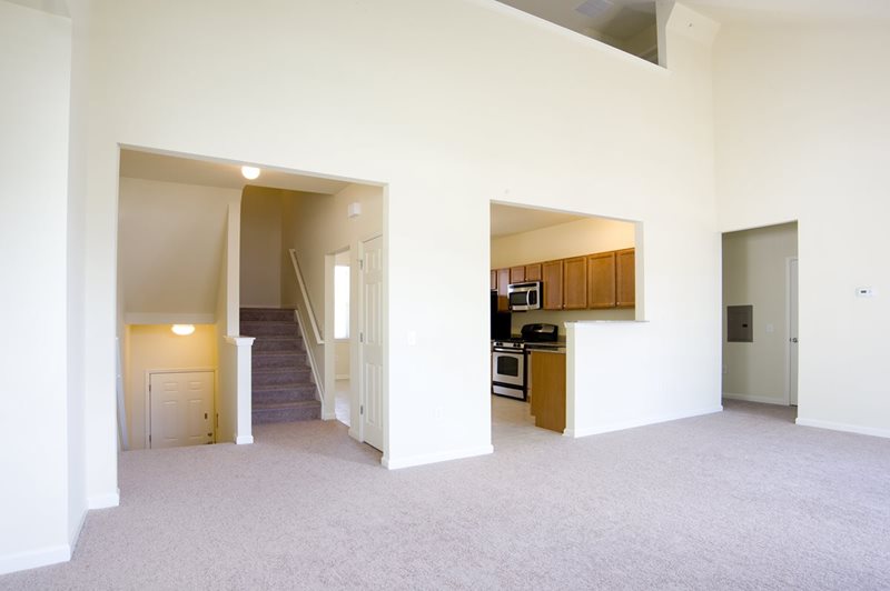 Cedar Manor's spacious apartment with kitchen and stairs leading up to the bedrooms.