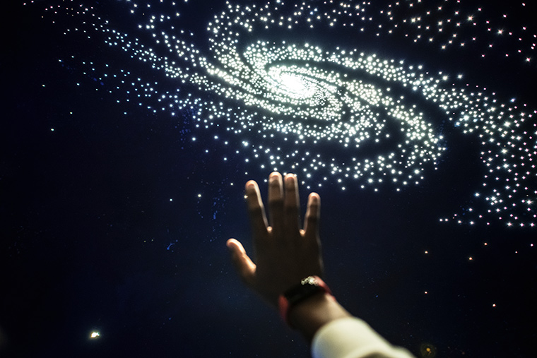 First person view looking at galaxy in a planetarium.